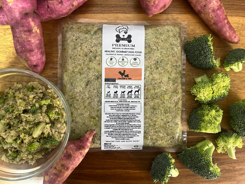 Pup Chef packaged gourmet dog food with ingredients on a wooden board from Amaloki